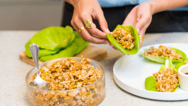 Hands preparing fresh lettuce wraps