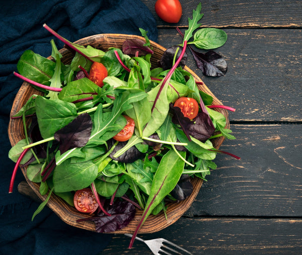 Fresh salad in wooden bowl