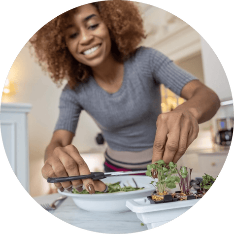 Woman preparing fresh greens in kitchen