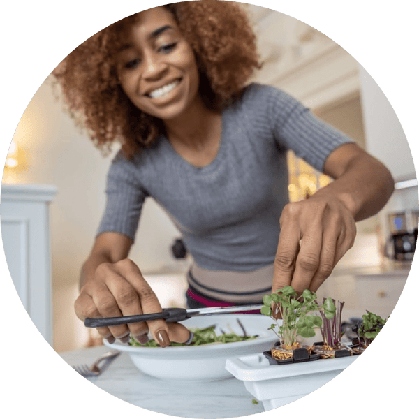 Woman preparing fresh greens in kitchen