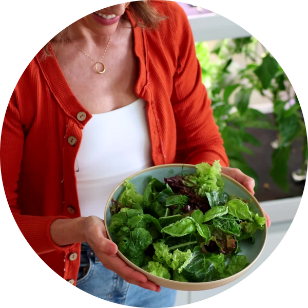 Person holding bowl of greens